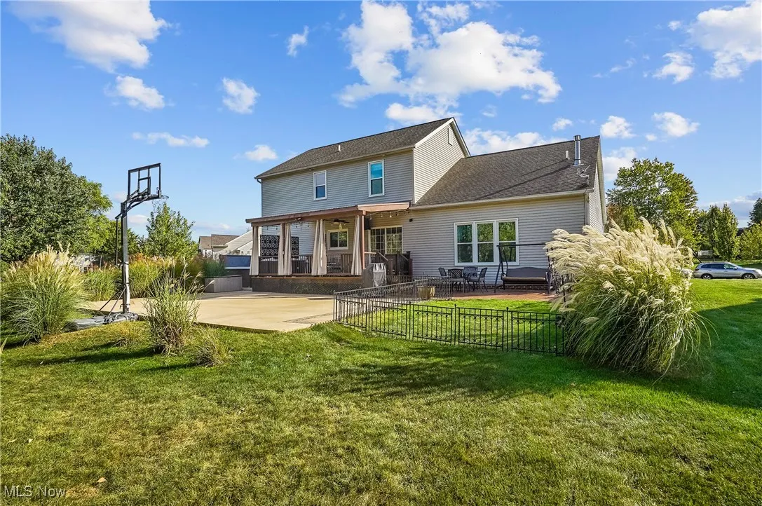 Rear view of property featuring a patio area and a yard