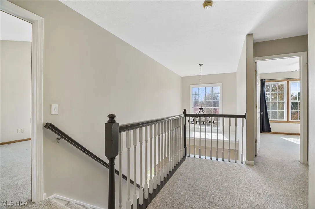 Stairway with carpet flooring and baseboards
