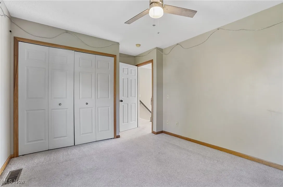 Unfurnished bedroom with carpet flooring, a closet, and ceiling fan