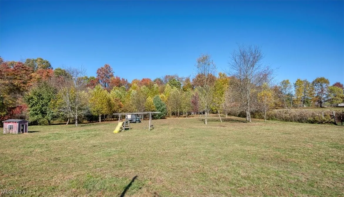 View of green lawn featuring a playground