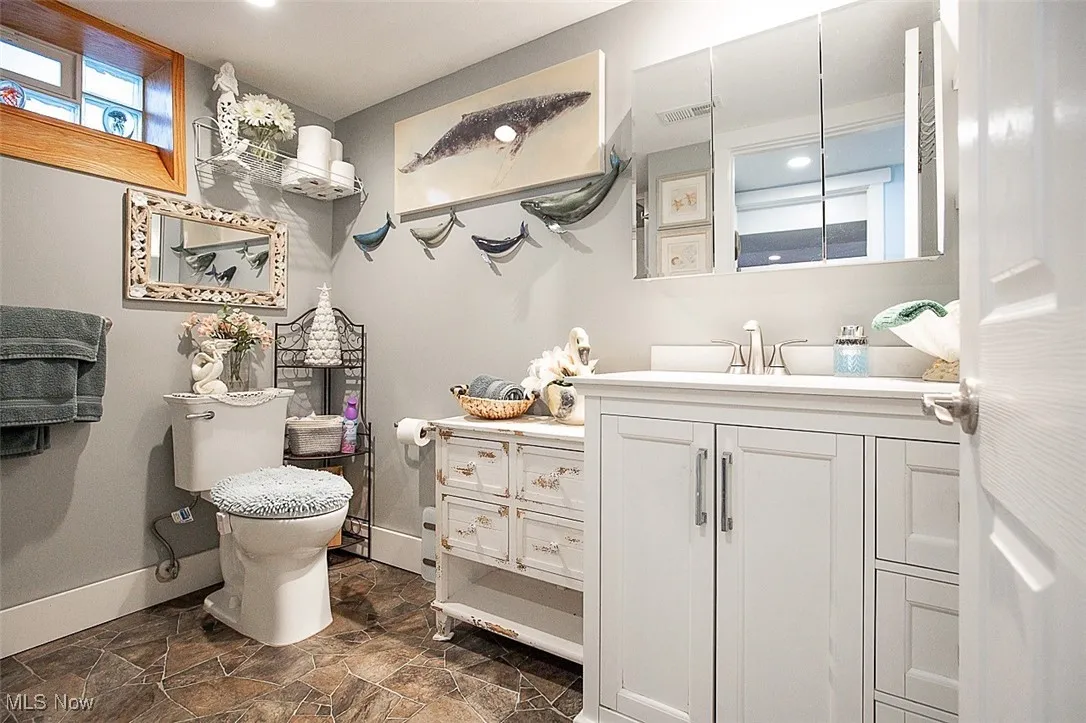 Full bathroom with vanity and dark stone finish flooring (Basement)