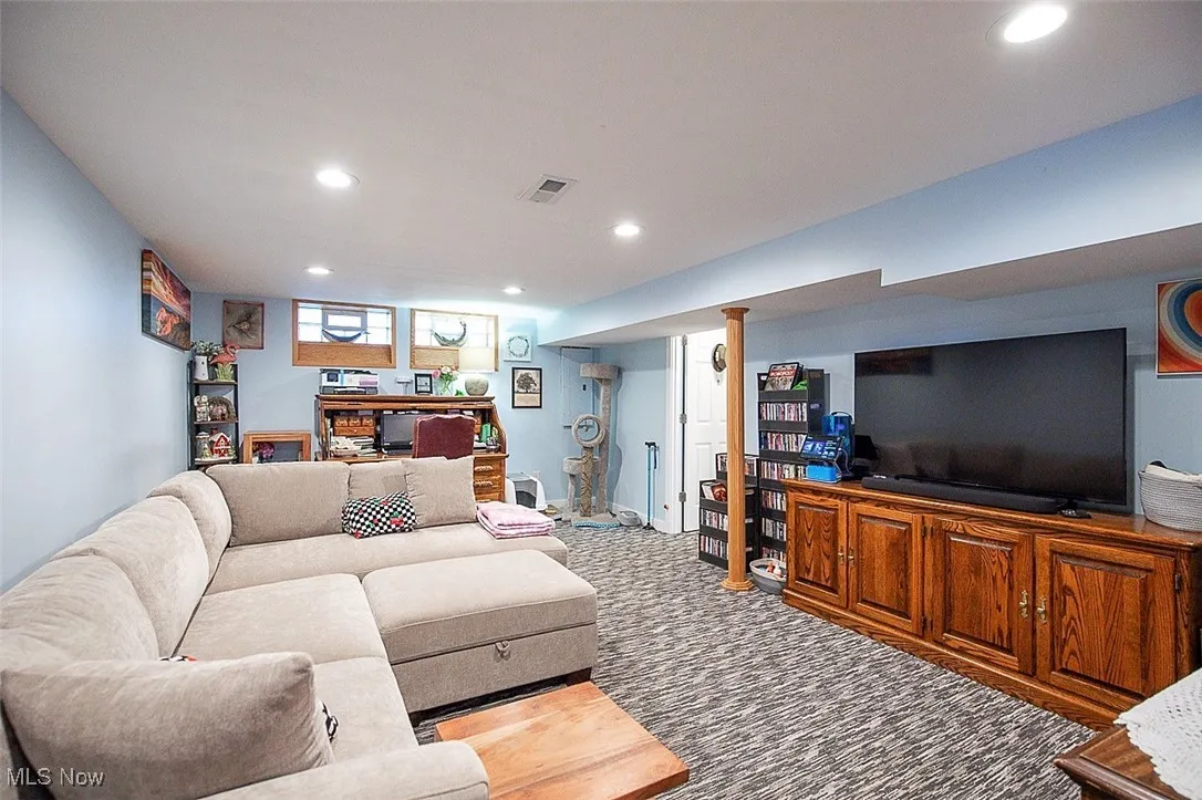 Carpeted living area featuring recessed lighting