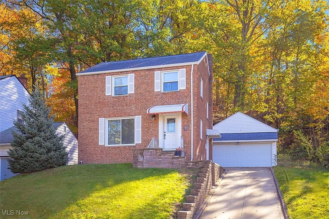Brick colonial-style home with 2 car detached garage