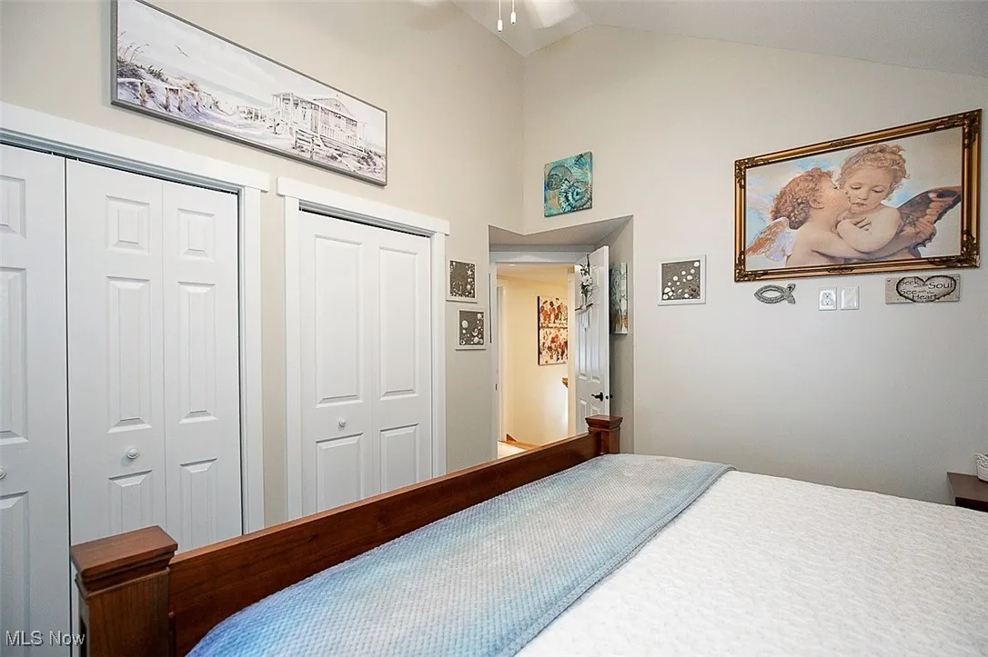 Bedroom featuring two closets and vaulted ceiling