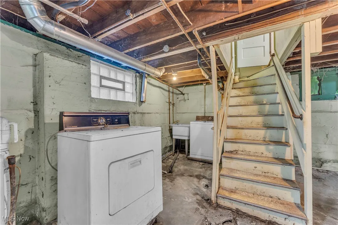 Basement featuring washer / clothes dryer and stairway