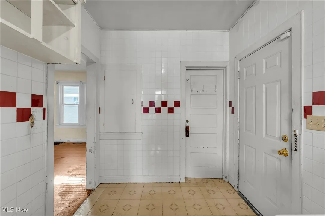 Hall with tile walls and light flooring