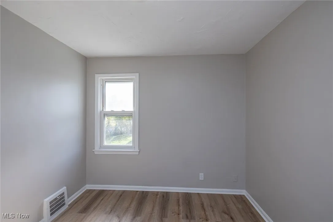 Unfurnished room featuring light wood-style flooring and baseboards