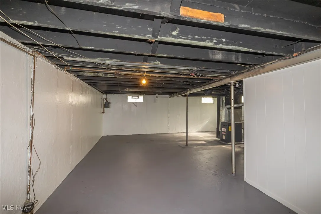 Basement featuring heating unit