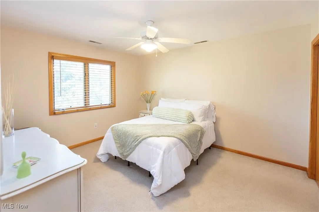 Bedroom with carpet and ceiling fan