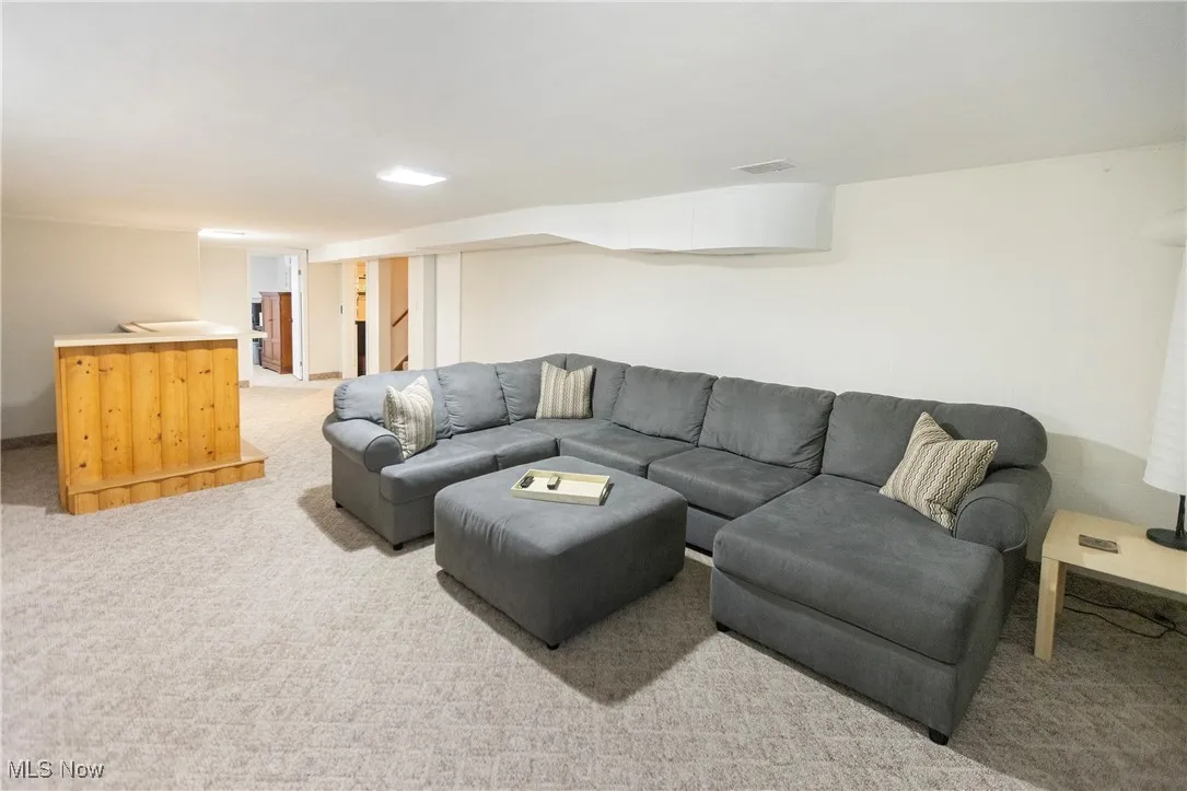 Living area with light colored carpet