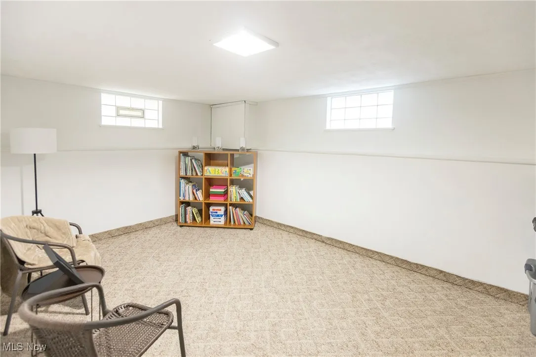 Living area featuring baseboards and carpet floors