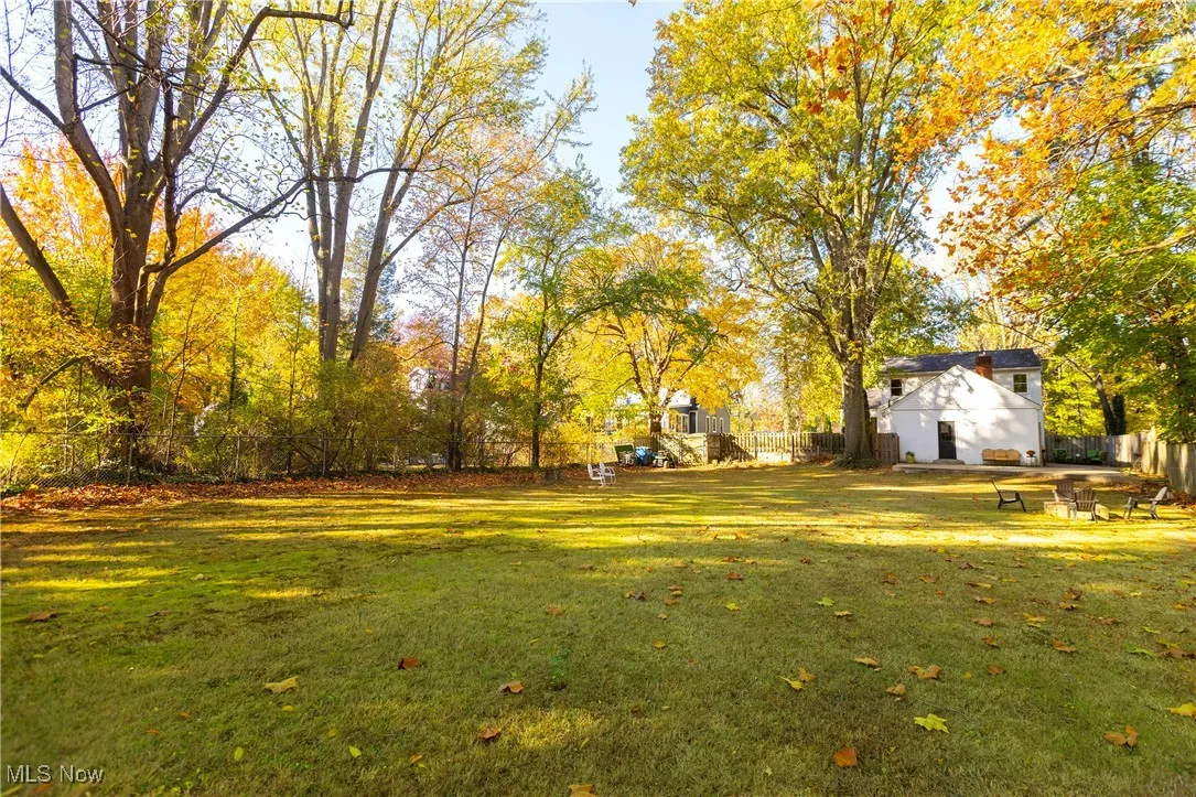 View of yard with view of scattered trees and a patio