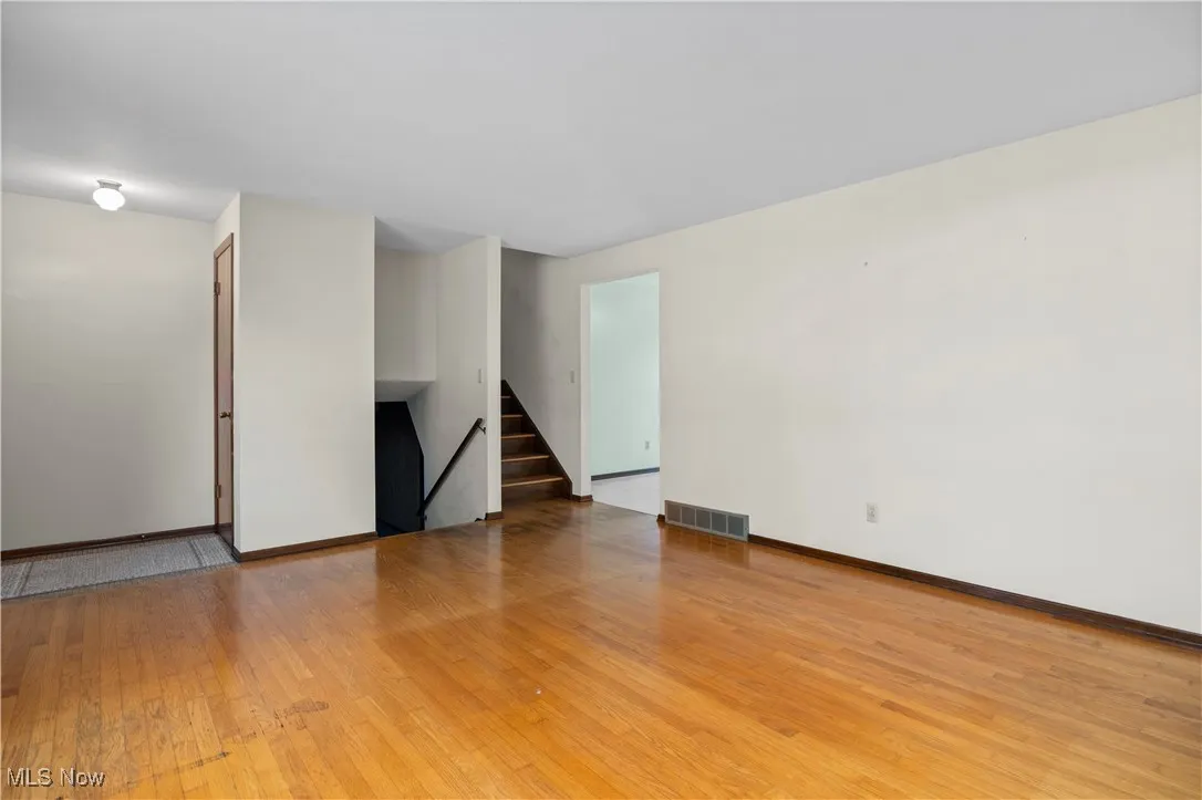 Living room looking towards steps up and down, and entrance to kitchen