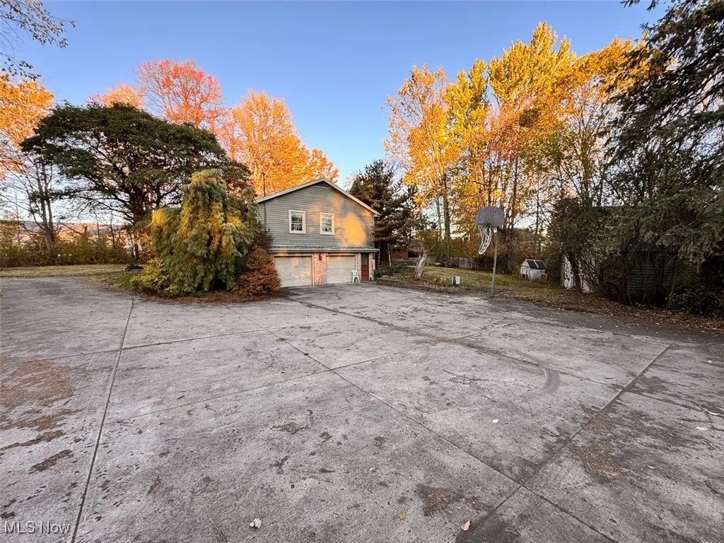 View of side of property featuring driveway and a garage