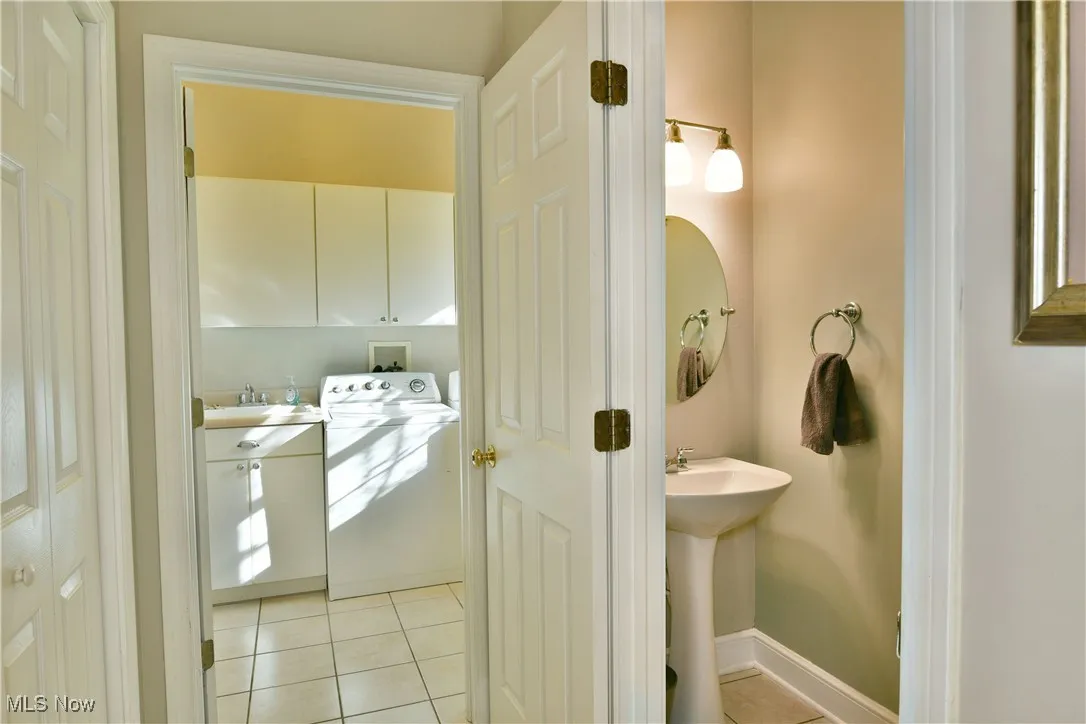 Bathroom featuring light tile patterned floors and washer / clothes dryer