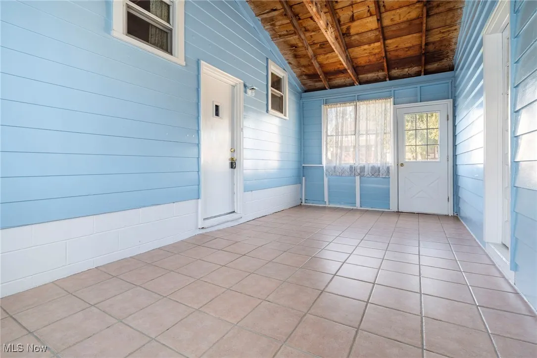 Breezeway-door to the left is to the house, door to the front is to the driveway and door on the right is to garage y