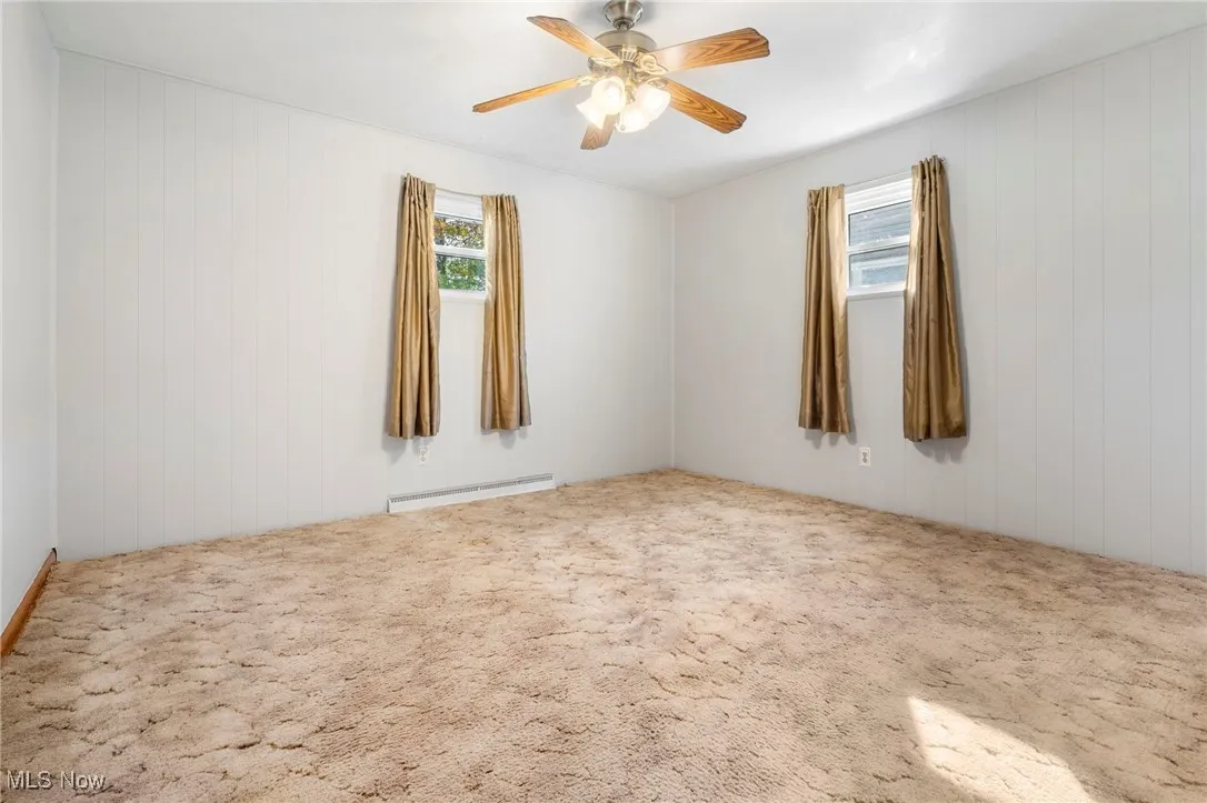 Master bedroom with plenty of natural light, carpet flooring, freshly painted walls, and ceiling fan/light