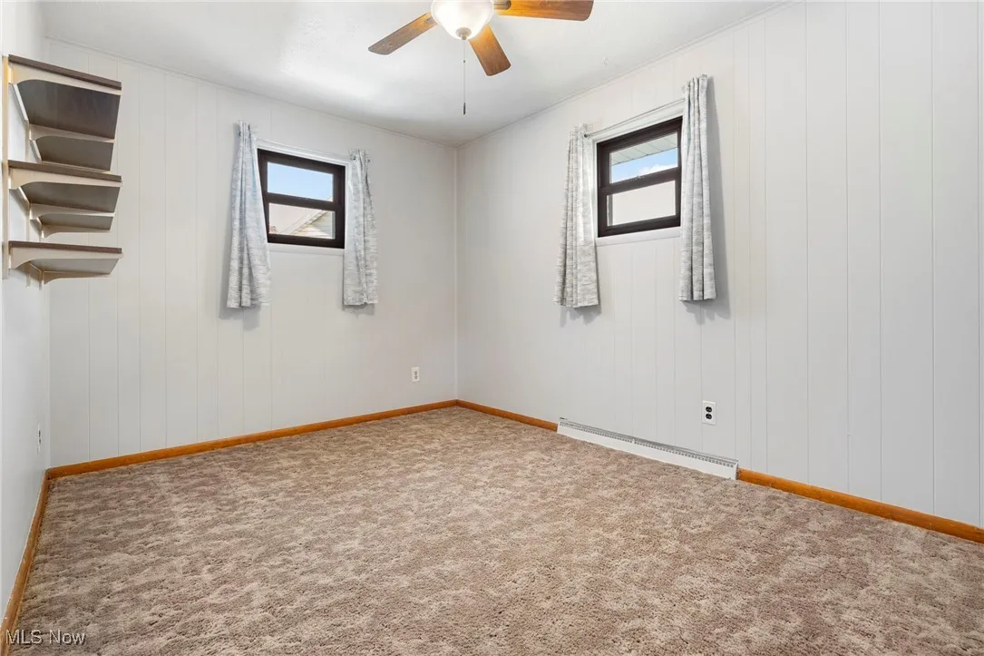 Carpeted Bedroom #3 with freshly painted walls, ceiling fan/light and shelves