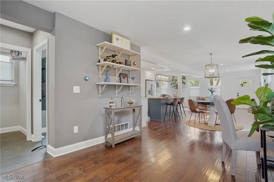 Dining area with dark wood-style flooring, a chandelier, and recessed lighting