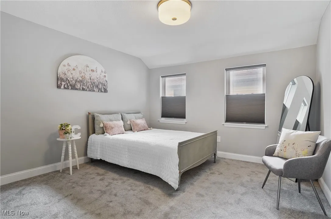 Bedroom with carpet and vaulted ceiling