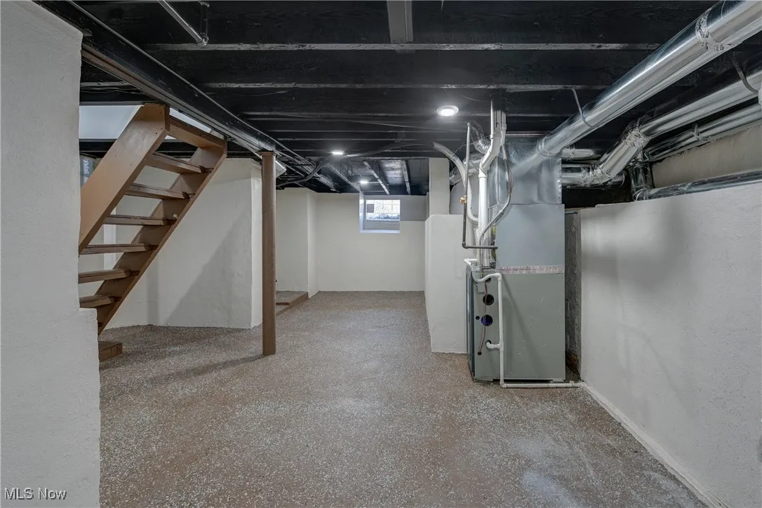 Below grade area with stairway and heating unit