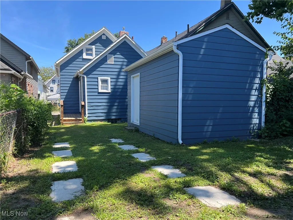 Rear view of property featuring a chimney