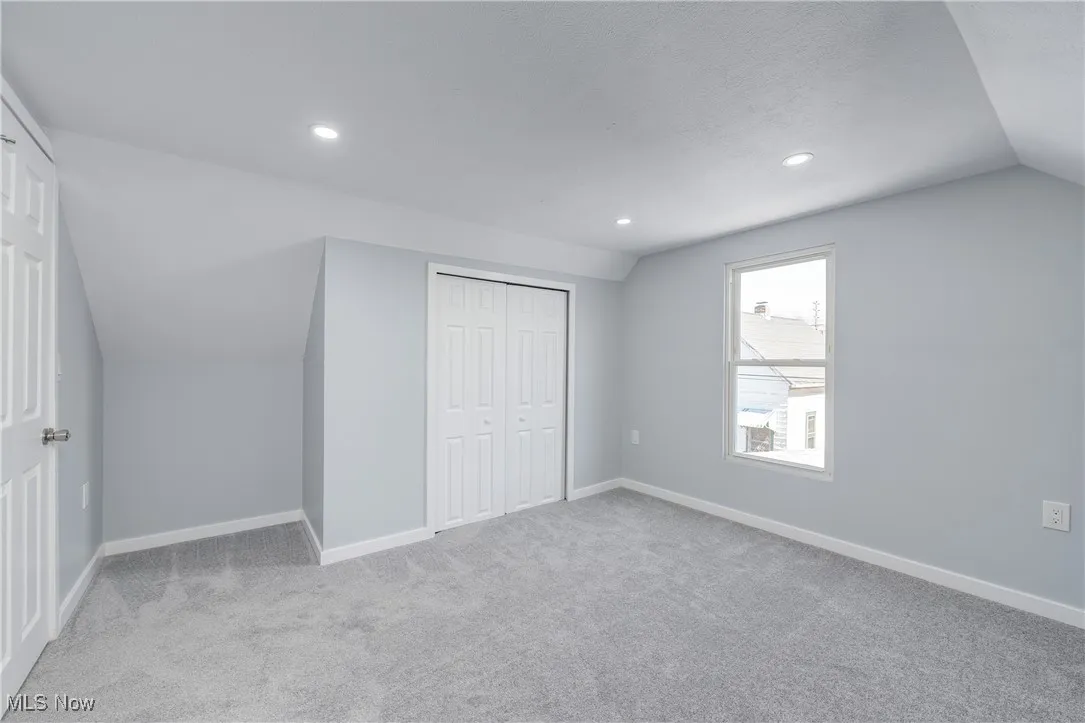 Unfurnished bedroom with baseboards and carpet flooring