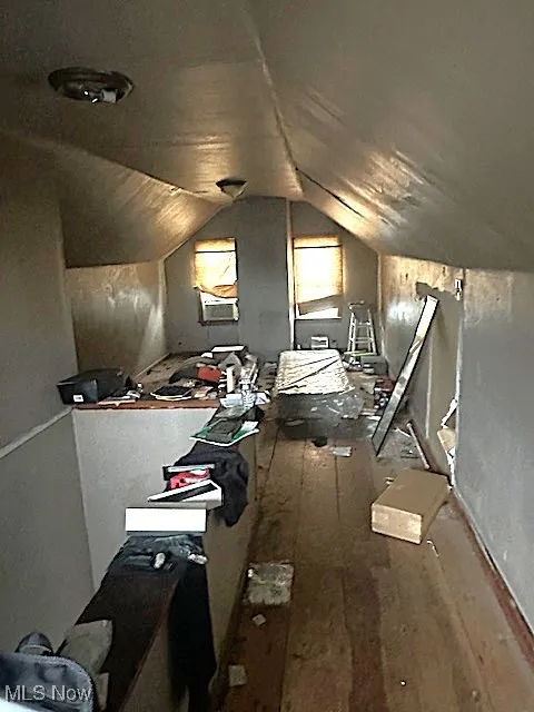 Bonus room with lofted ceiling and hardwood / wood-style flooring