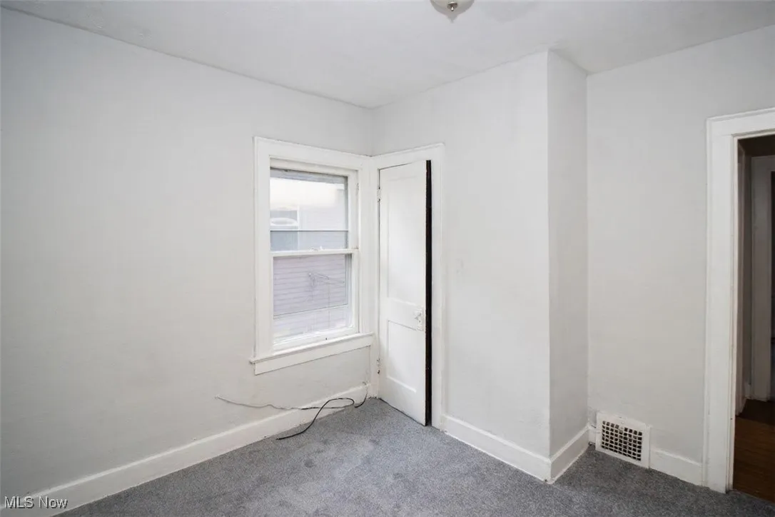 Unfurnished bedroom with carpet and baseboards