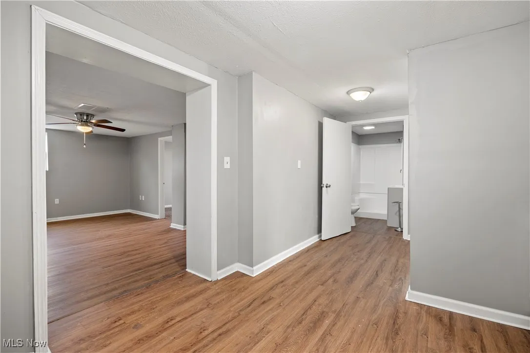 Corridor with light wood finished floors and baseboards
