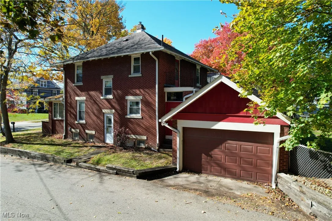 View of home's exterior featuring brick siding and a chimney
