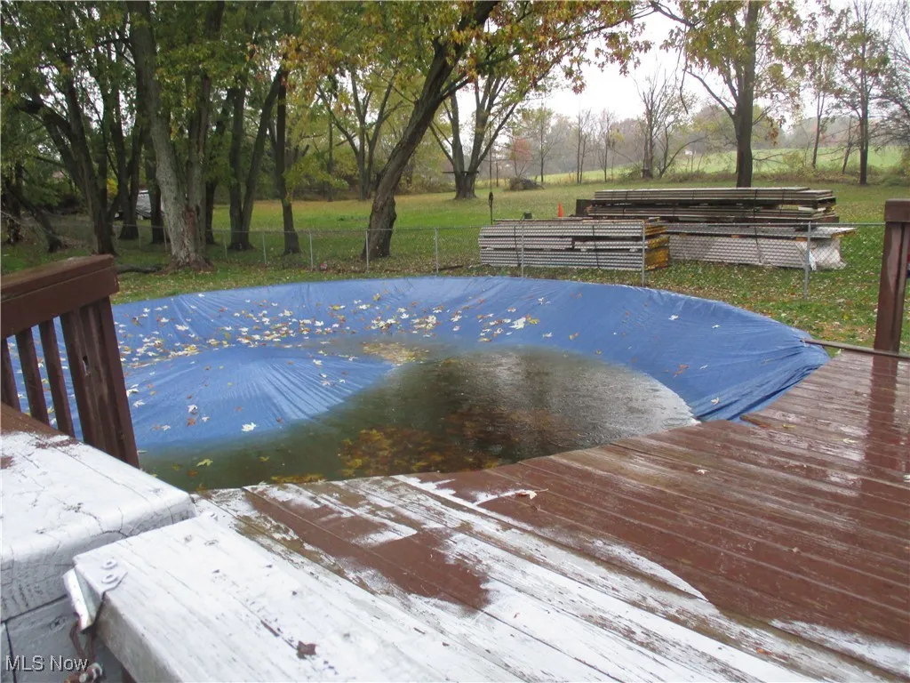 View of pool featuring a covered pool and a deck