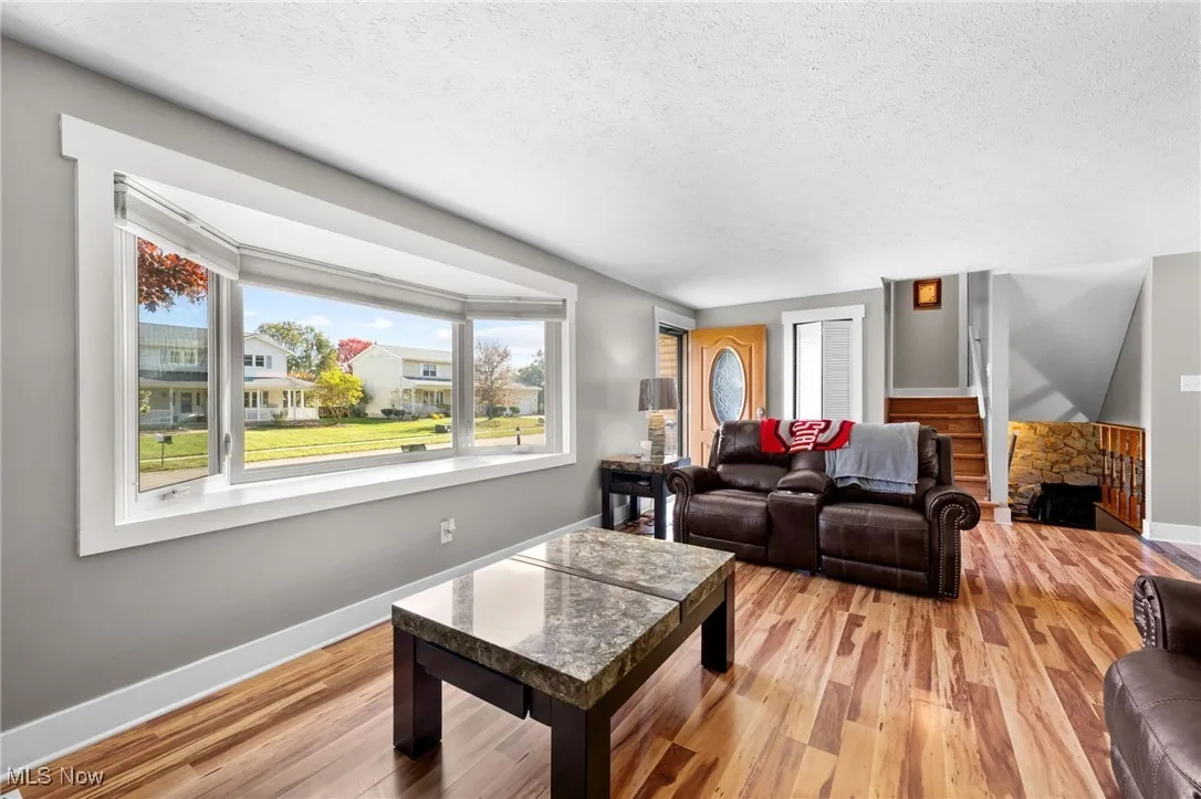 Living room featuring a textured ceiling and light wood finished floors