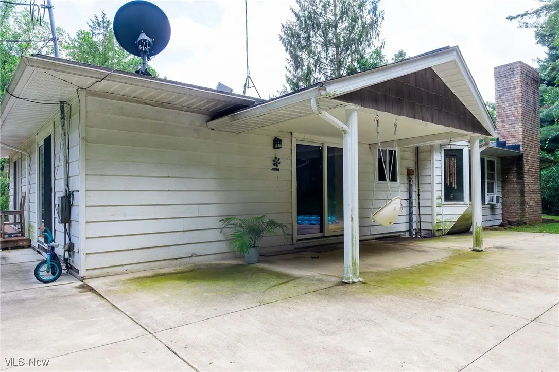 Rear view of house featuring a chimney