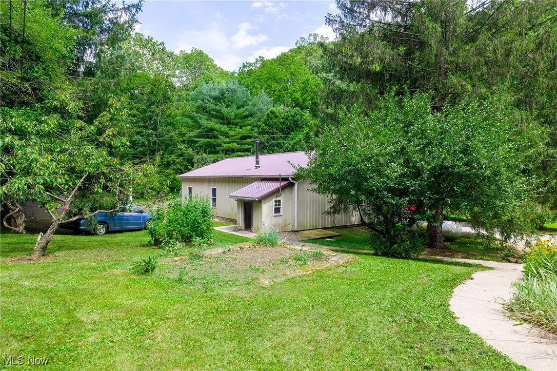 Rear view of house featuring a lawn