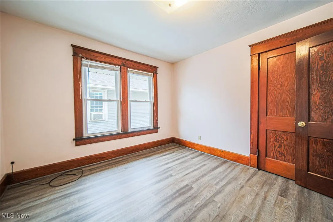 Empty room featuring wood finished floors and baseboards