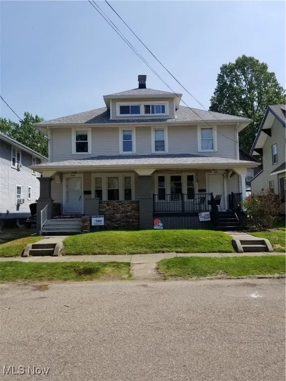 American foursquare style home featuring covered porch