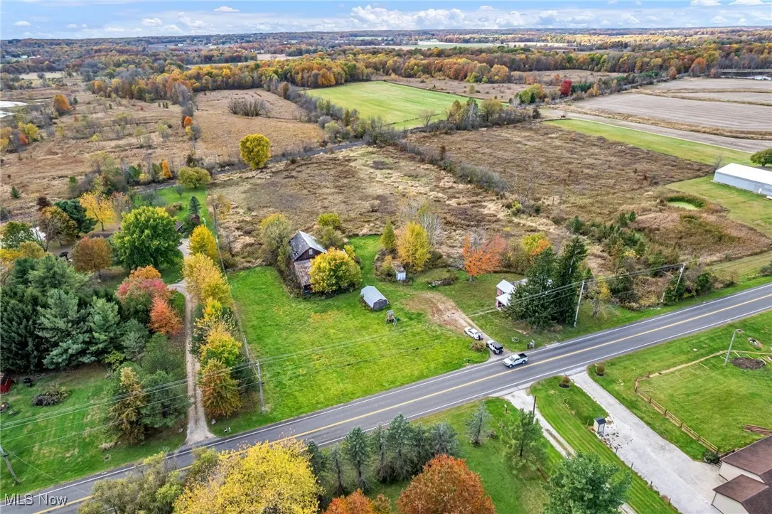 Aerial view of sparsely populated area with a tree filled landscape
