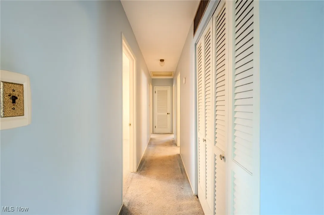 Hall featuring carpet floors and baseboards