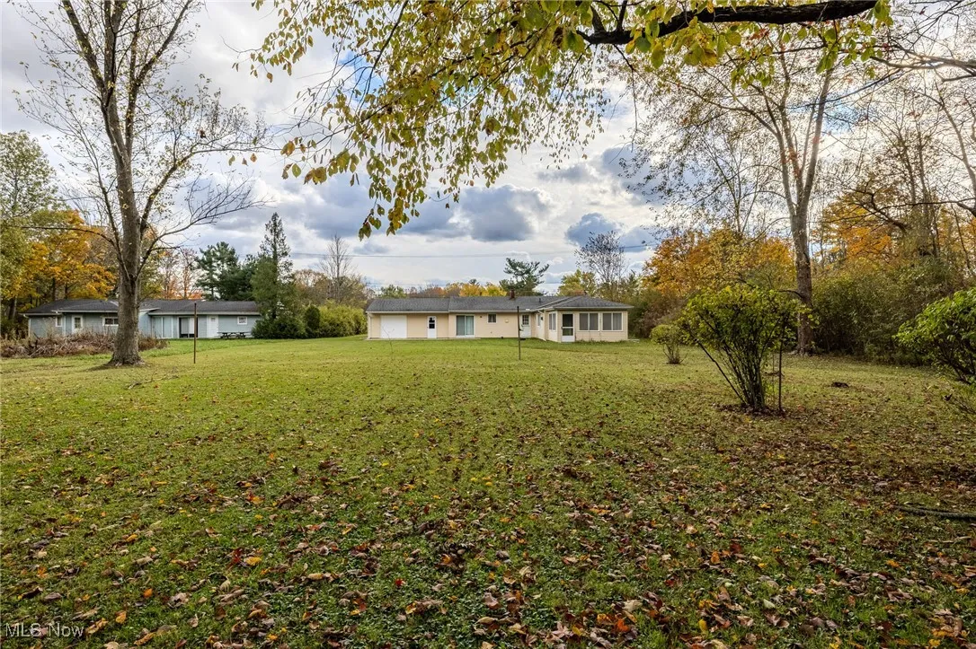 Rear view of house featuring a yard