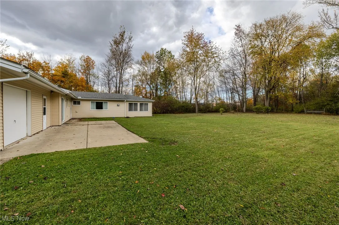 View of green lawn featuring a patio area