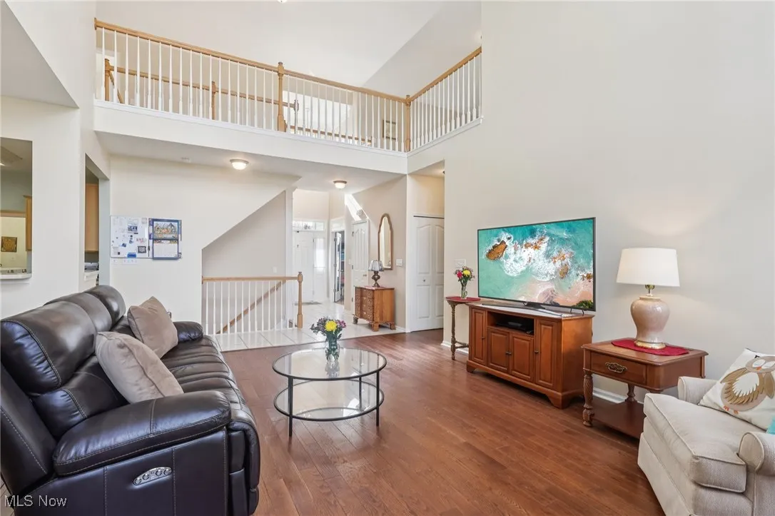 Living room with dark wood finished floors and a high ceiling