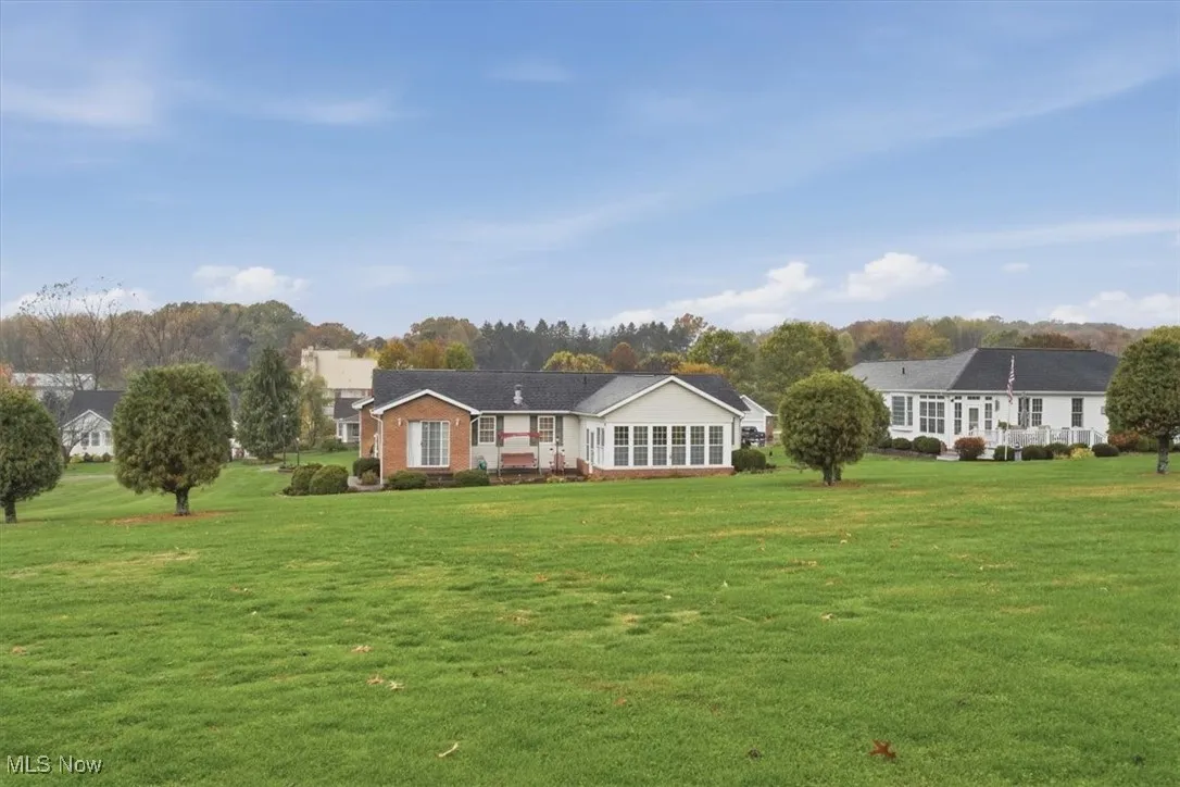 Rear view of house with a lawn