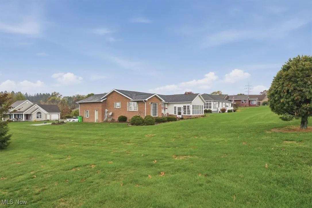 Single story home featuring a front lawn and brick siding