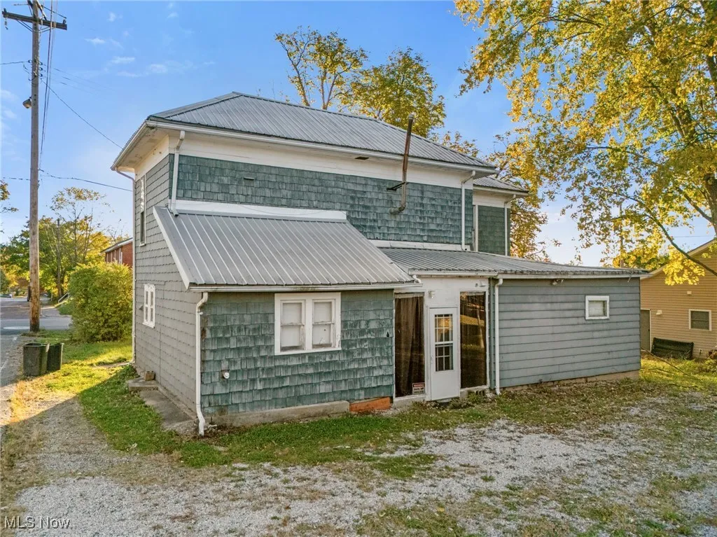 Rear view of property with a metal roof