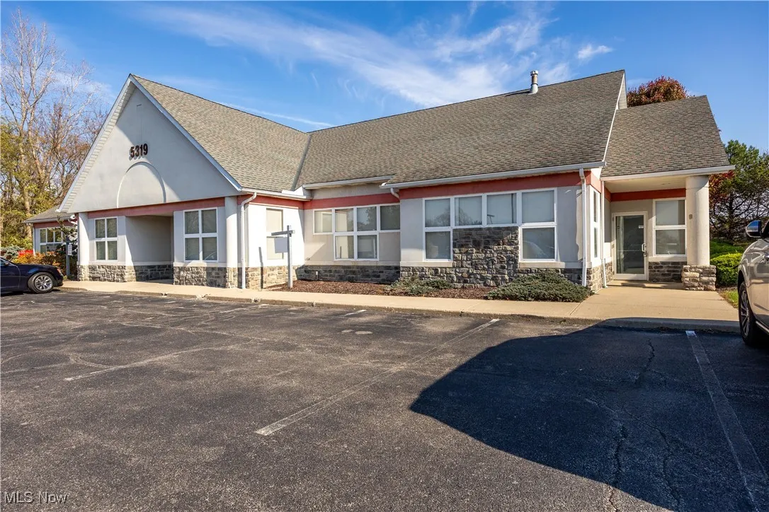 View of building exterior with uncovered parking