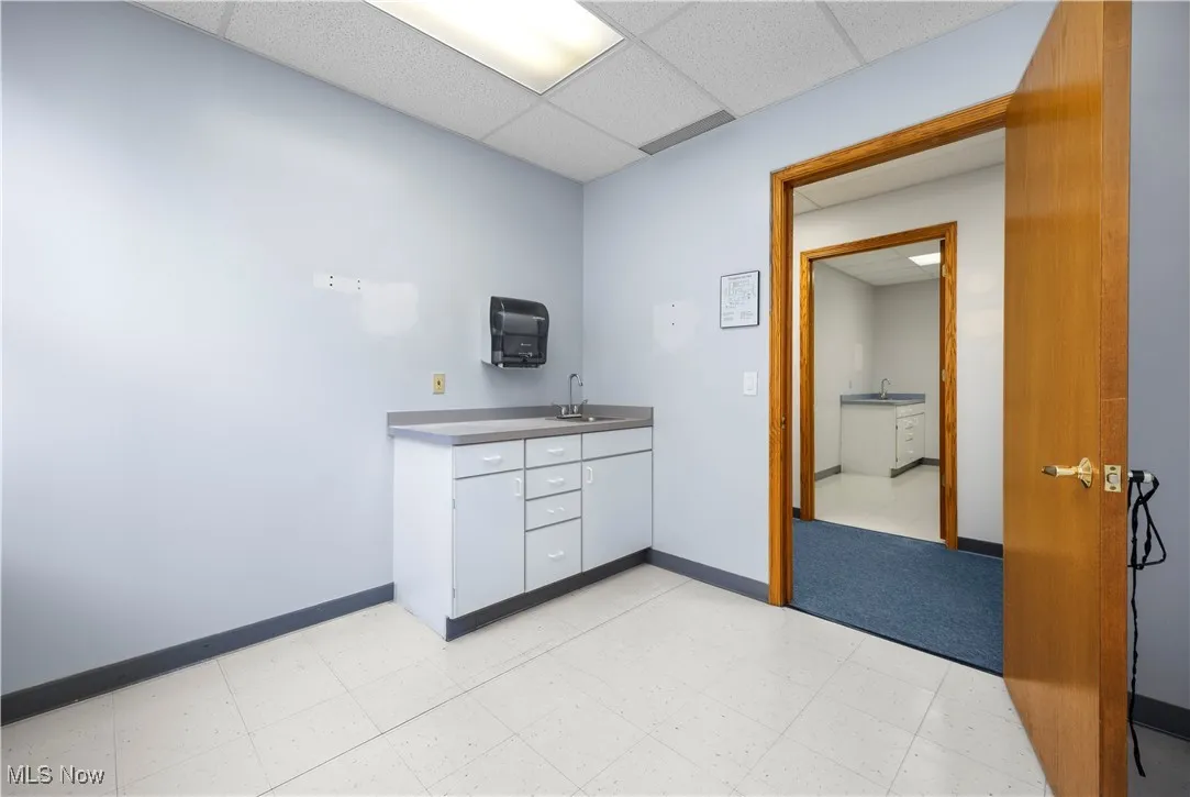Kitchen featuring a paneled ceiling and dark countertops