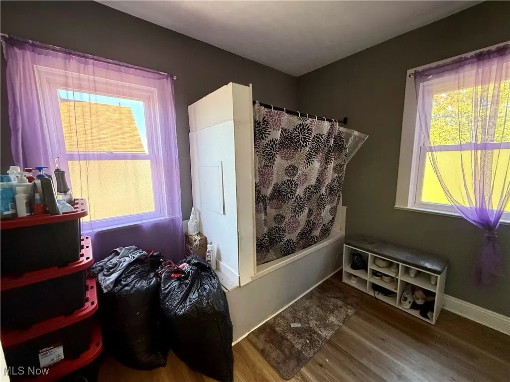 Bedroom featuring wood finished floors and baseboards