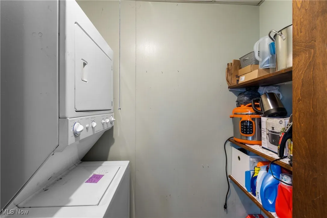 Laundry room featuring stacked washer / drying machine