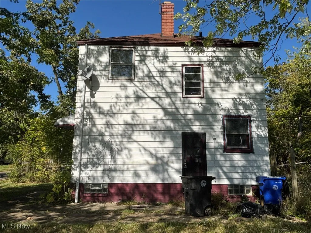 View of property exterior with a chimney